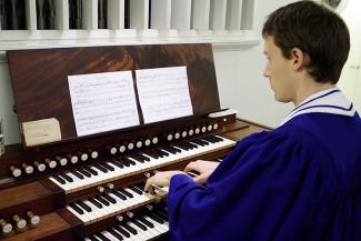 Student playing the organ