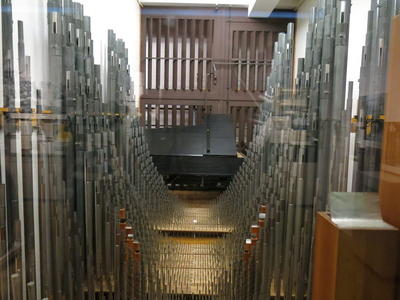 Organ pipes with grand piano in background