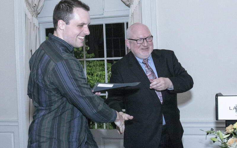 Martin Jean giving a diploma to a student