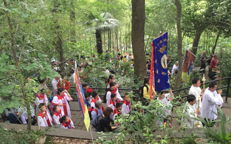 Catholic pilgrims processing up Sheshan Mountain