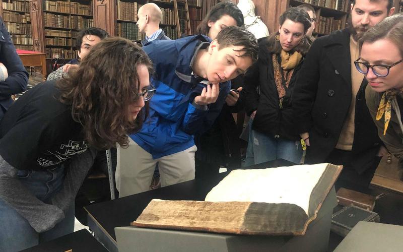 Elizabeth Buckheit and Ben Gee looking at Foxe's Book of Martyrs at the Wren Library, Trinity College, Cambridge. Photo- Sarah Fox