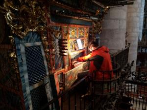 SM organ student Nicholas Quardokus tries out a centuries-old cathedral organ (photo by David Simon)