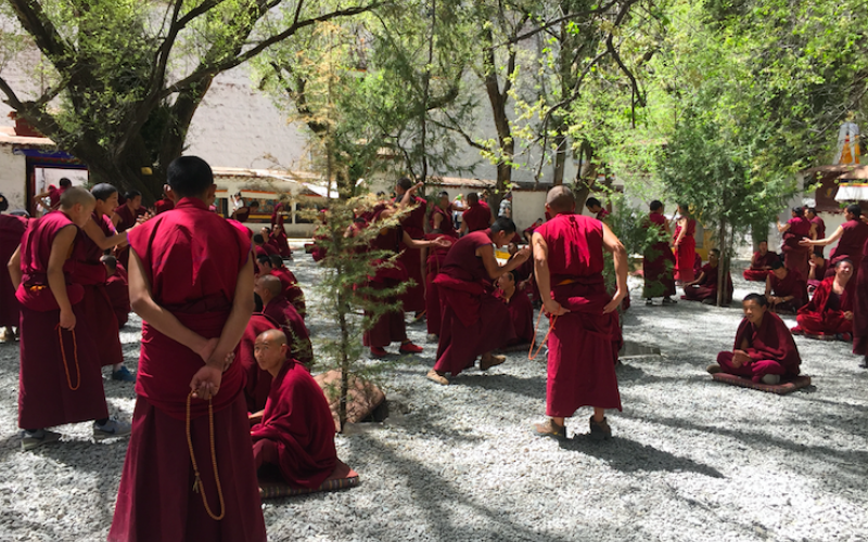 Tibetan Buddhist monks engaging in philosophical debates at Sera Monastery