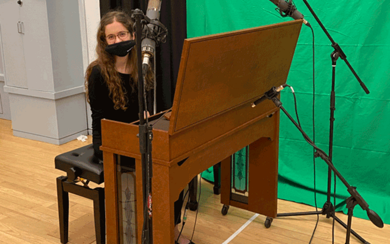 student with mask at a piano