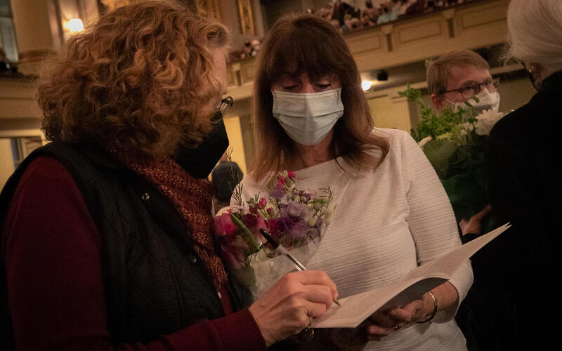 Two women signing book