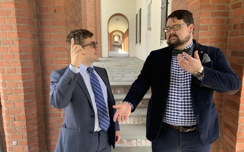 Two men walking and talking