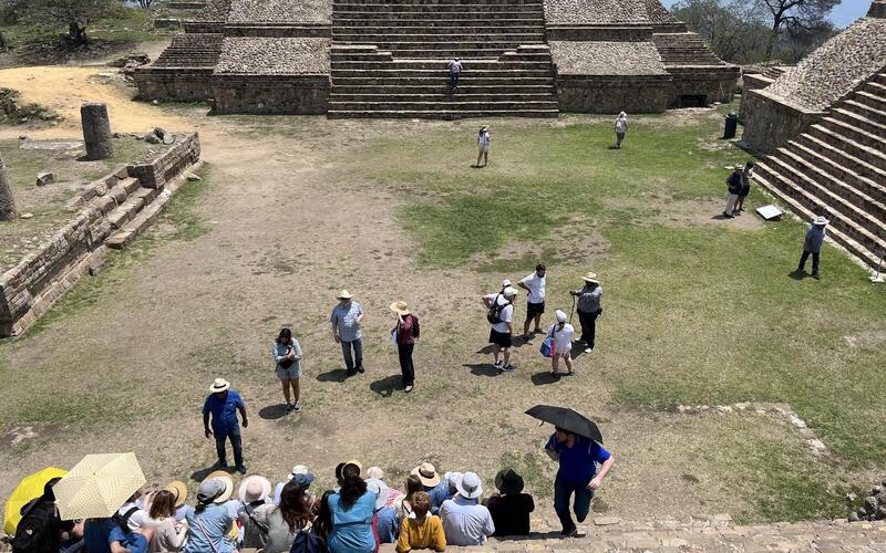 Gathering for a group photo on the steps of Monte Albán