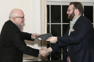 Martin Jean giving a diploma to a student