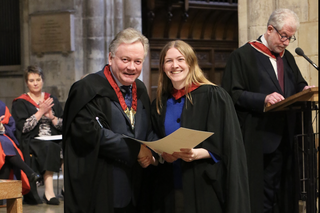 Carolyn Craig being presented with her diploma by David Hill at Southwark Cathedral