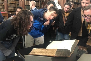 Elizabeth Buckheit and Ben Gee looking at Foxe's Book of Martyrs at the Wren Library, Trinity College, Cambridge. Photo- Sarah Fox