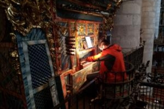 SM organ student Nicholas Quardokus tries out a centuries-old cathedral organ (photo by David Simon)