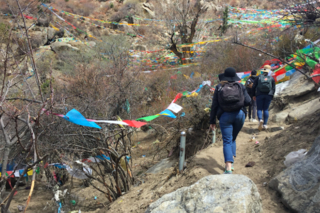 Students making the circular ascent up to Guru Rinpoche's meditation cave