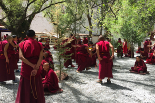 Tibetan Buddhist monks engaging in philosophical debates at Sera Monastery