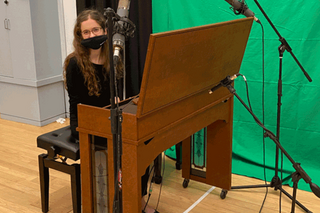 student with mask at a piano