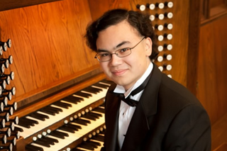 Jacob Reed, sitting at organ