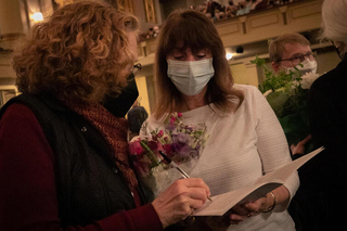 Two women signing book