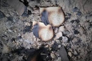 burnt papers in rubble