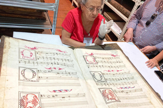 ISM students and faculty viewing one of the choir books at the Mexico City Cathedral