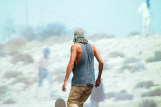 Man walking in front of a movie screen as part of a performance