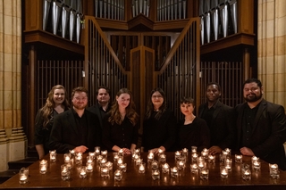 Yale Voxtet posing with candles in chapel