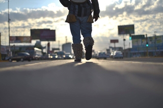 Photograph of person walking down street