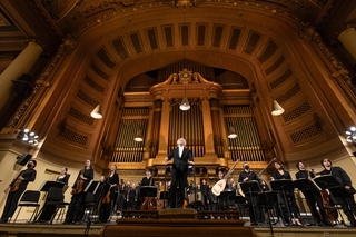 Masaaki Suzuki on stage with Schola Cantorum