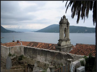 Balkan tour scene of cathedral overlooking water