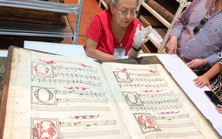 ISM students and faculty viewing one of the choir books at the Mexico City Cathedral